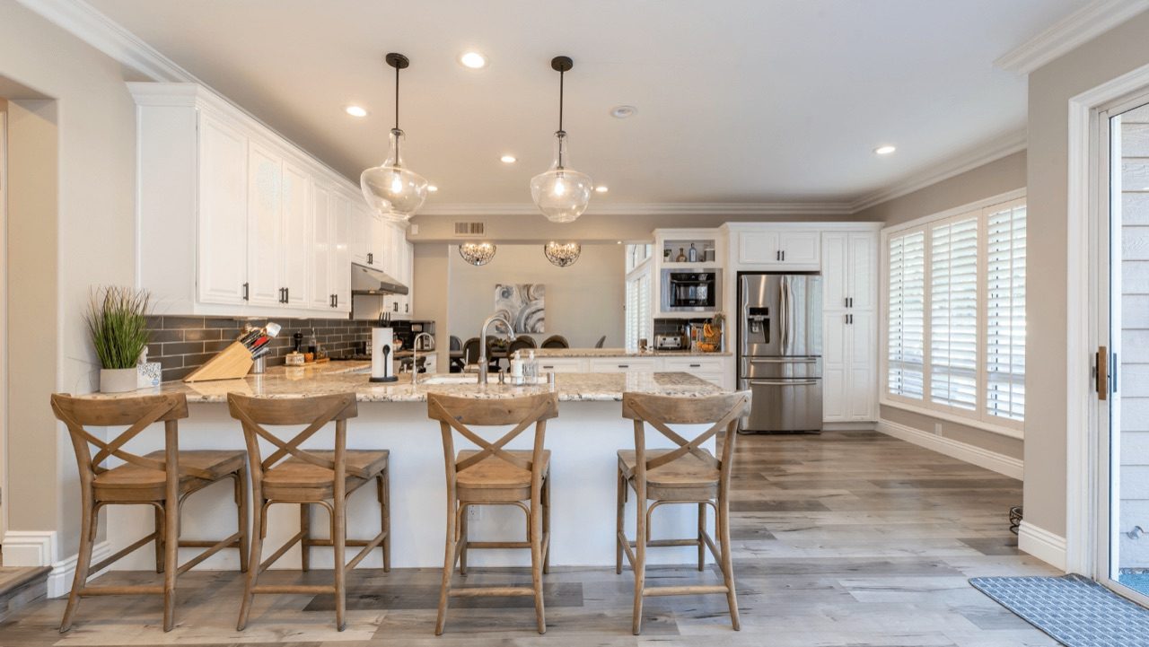 Modern kitchen remodel with dark cabinetry and marble countertops